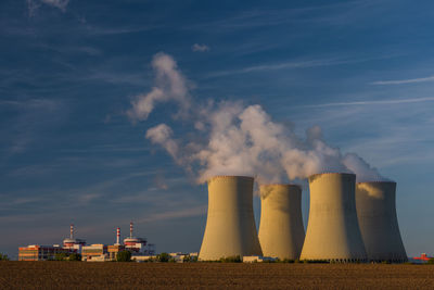 Smoke stacks against sky