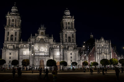 Group of people in front of building at night