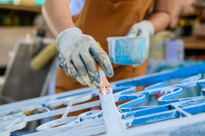Close-up of man working on ice cream
