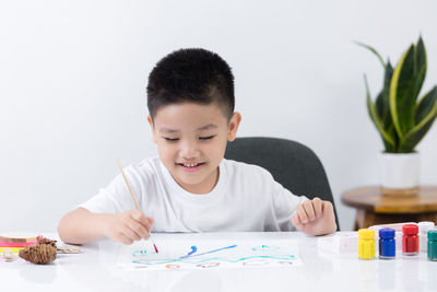 Boy looking at camera on table