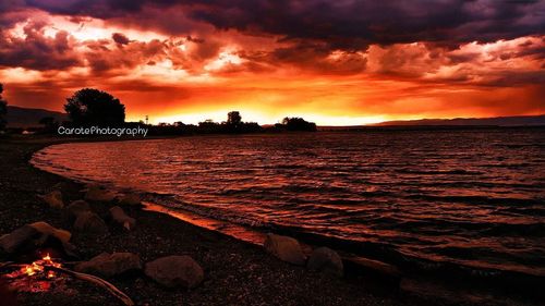 Scenic view of dramatic sky over sea during sunset