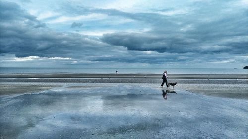 Man on beach against sky