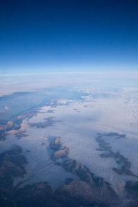 Aerial view of clouds over landscape against blue sky