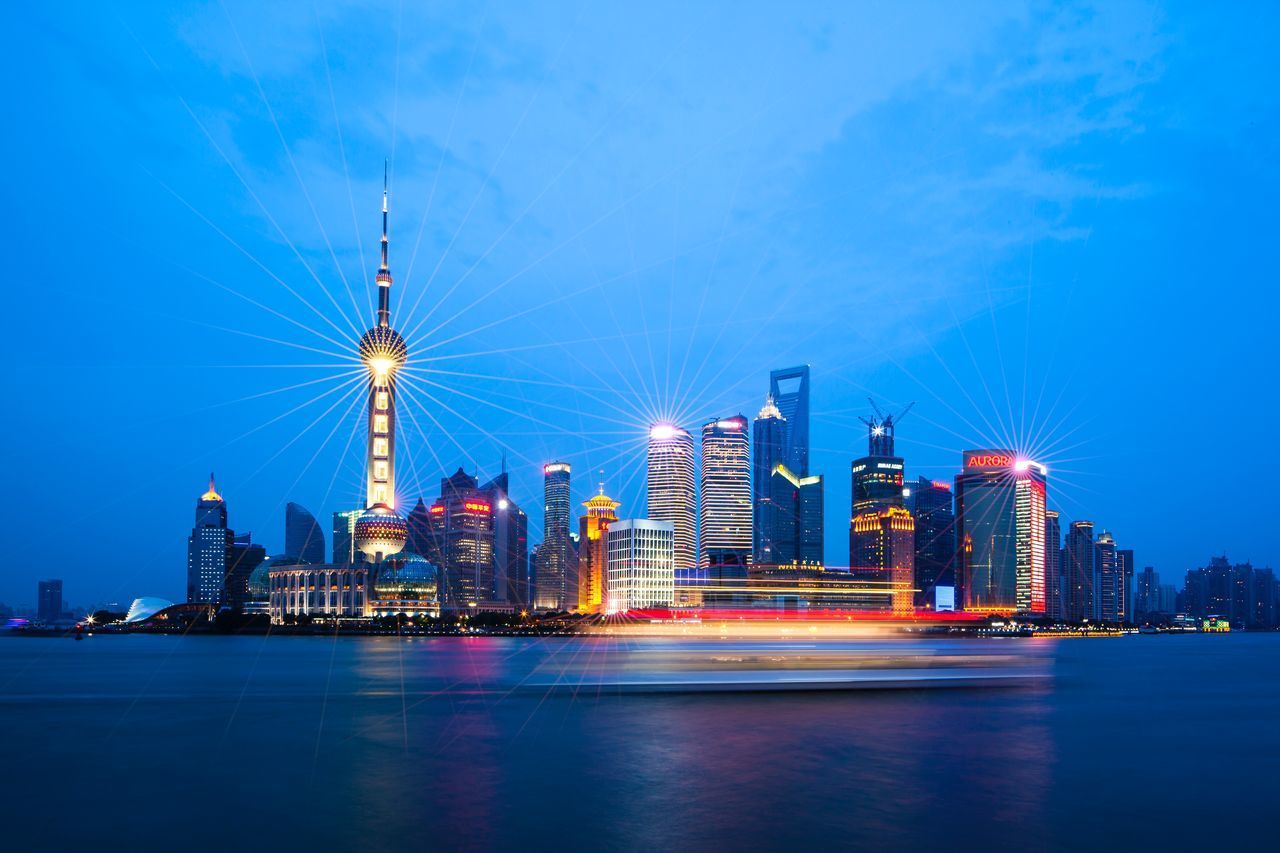 ILLUMINATED BUILDINGS IN CITY AT NIGHT