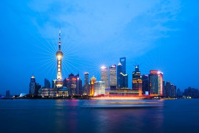 Illuminated buildings against sky at night