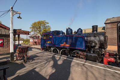 Train on railroad track against sky