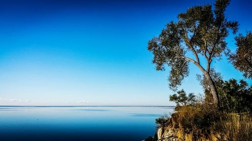 Scenic view of calm lake against blue sky