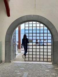 Rear view of people walking in corridor of building