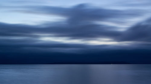 Scenic view of sea against storm clouds