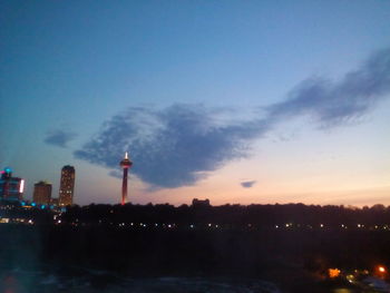 Illuminated cityscape against sky