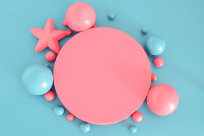 Pink christmas composition on the blue background. trendy xmas background, mockup. free space