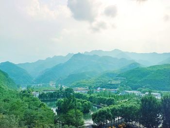 Scenic view of landscape and mountains against sky