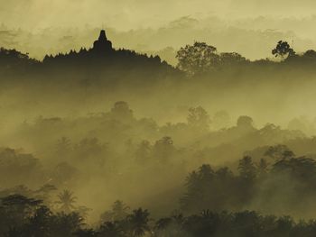 Borobudur temple with morning mist and sun ray of light