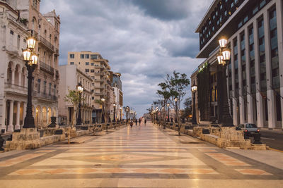 Street amidst buildings in city against sky