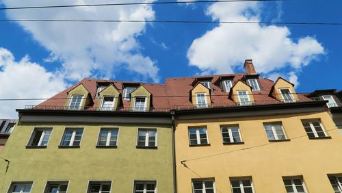 Low angle view of building against cloudy sky