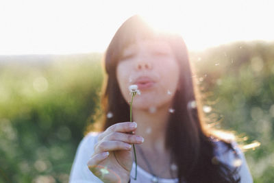 Close-up of woman hand holding grass