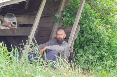 High angle view of boy sitting on grass