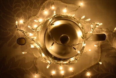 Close-up of illuminated string lights on teapot
