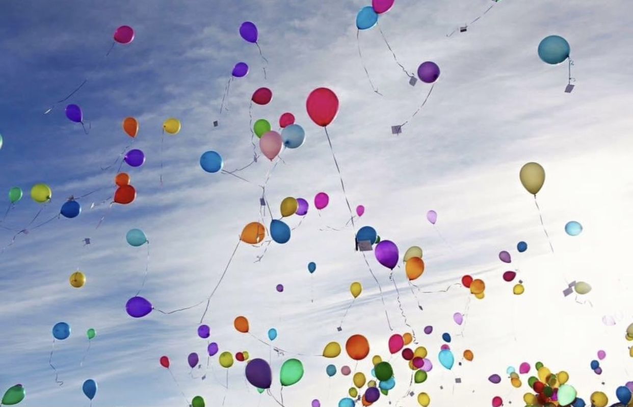 LOW ANGLE VIEW OF BALLOONS AGAINST BLUE SKY