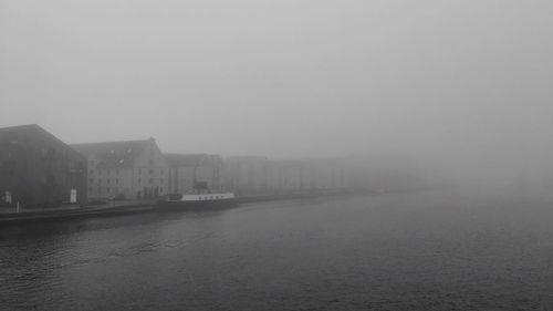 City at waterfront during foggy weather