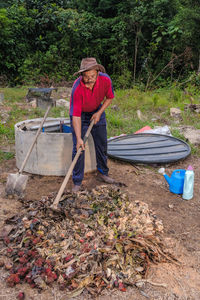 Full length of man holding umbrella while standing on land