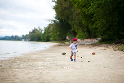 Cute boy walking on beach
