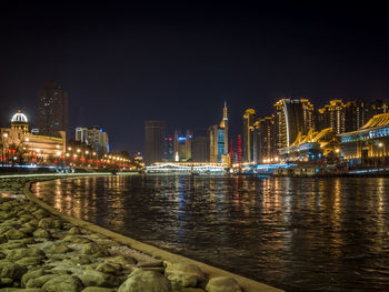 Illuminated city at waterfront