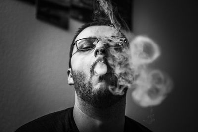 Close-up portrait of man smoking 