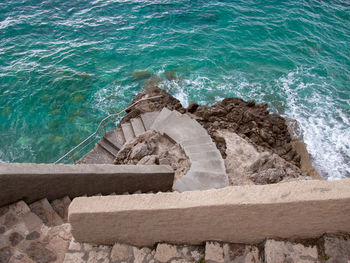 High angle view of stone steps on beach