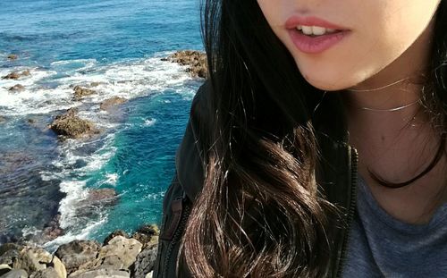 Close-up portrait of young woman at beach