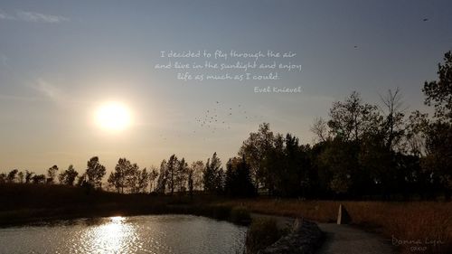 Scenic view of lake against sky at sunset