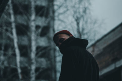 Side view portrait of man standing in snow