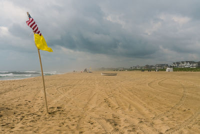 Scenic view of beach against stormy sky