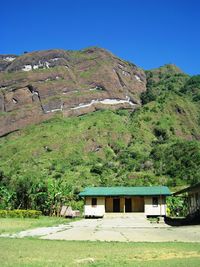 Scenic view of landscape and mountains against clear sky