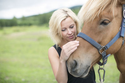 Young woman with horse