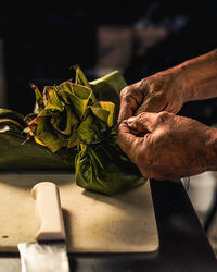 Cropped hand of person preparing food