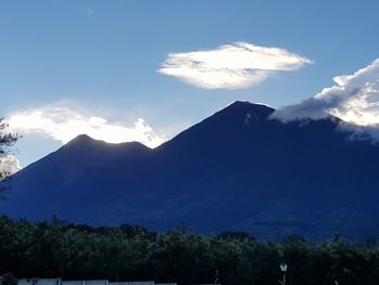 Low angle view of mountains against blue sky