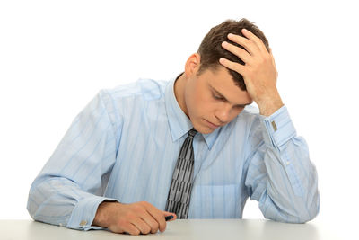 Man sitting on table against white background