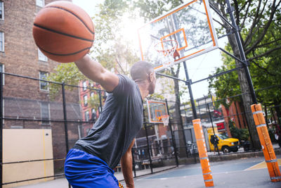 Young man playing basketball at court