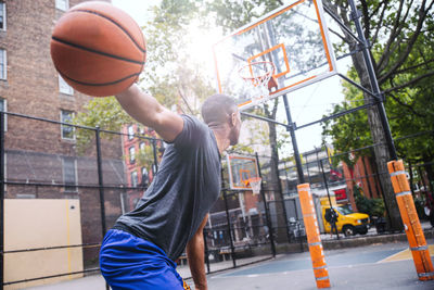 Man playing with basketball hoop