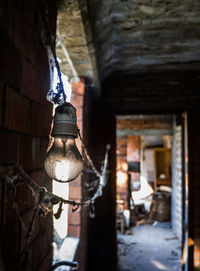 Low angle view of hanging light against building