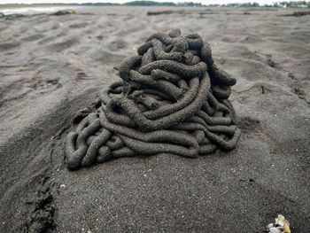 Close-up of rope tied on sand