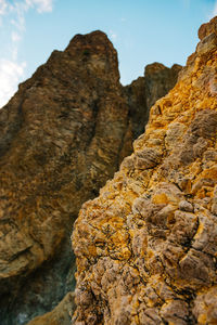 Low angle view of rock formation against sky