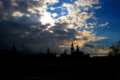 Buildings against cloudy sky