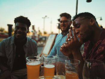 Portrait of a young man drinking glass