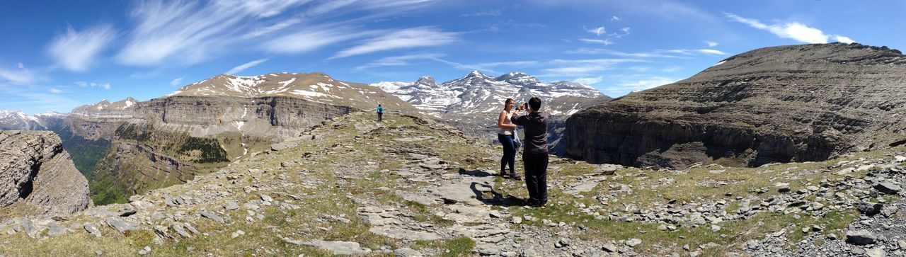 mountain, leisure activity, lifestyles, men, sky, hiking, full length, adventure, landscape, mountain range, rock - object, nature, tranquility, person, tranquil scene, snow, rock formation, low angle view