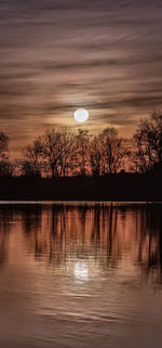 Scenic view of lake against sky at sunset