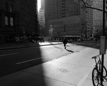 Shadow of man on street in city