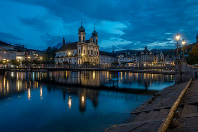 Reflection of buildings in river at night