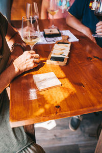 Midsection of people on table at restaurant